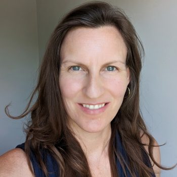 The head of a woman facing the camera. She has long hair.